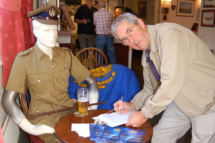 Alan Toms signing in