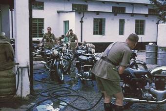 1965 Cleaning motorcycles at Cranborne Driving School after a cross-country ride
